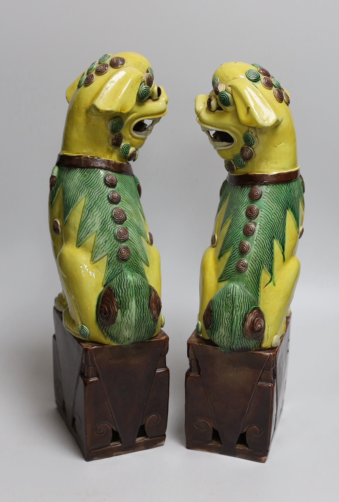 A pair of tall Chinese sancai glazed Buddhist lions, Republic, 36cms high